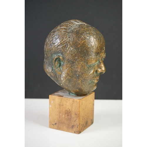 150 - Bronze Bust of Sir Winston Churchill raised on a wooden plinth, 20cm high