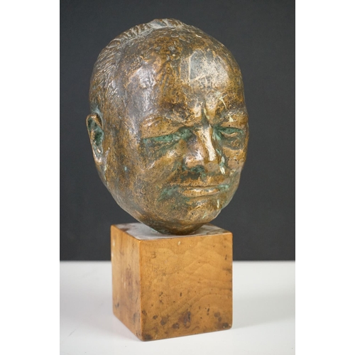 150 - Bronze Bust of Sir Winston Churchill raised on a wooden plinth, 20cm high