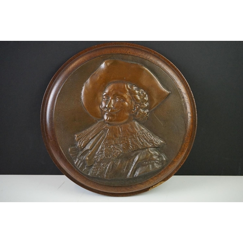 170 - Bronze Circular Plaque depicting the Laughing Cavalier in relief, 22cm diameter mounted on a wooden ... 