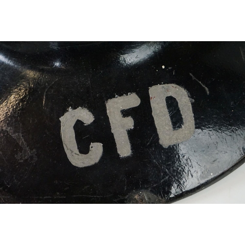 196 - A vintage hard boiled fibreglass fireman's helmet, painted black and marked CFD (Chicago Fire Depart... 