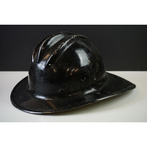 196 - A vintage hard boiled fibreglass fireman's helmet, painted black and marked CFD (Chicago Fire Depart... 