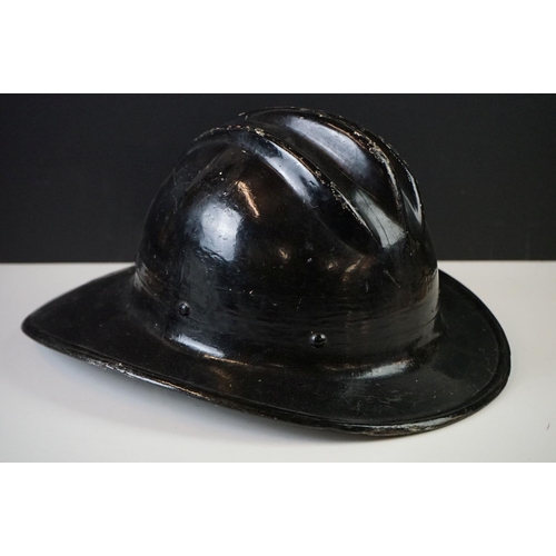 196 - A vintage hard boiled fibreglass fireman's helmet, painted black and marked CFD (Chicago Fire Depart... 