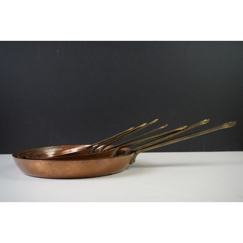 198 - Set of Seven Copper Graduating Frying Pans with brass handles, each pan stamped from 1 to 7, largest... 