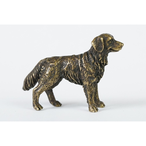 213 - A miniature bronze figure of a golden retriever dog.