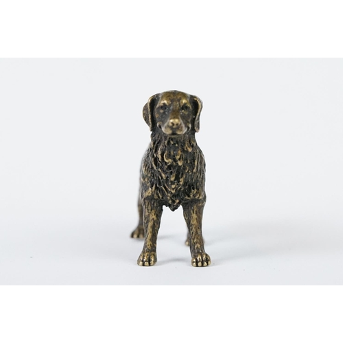 213 - A miniature bronze figure of a golden retriever dog.