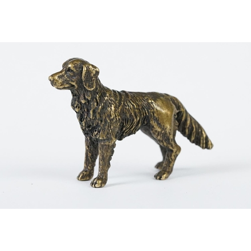 213 - A miniature bronze figure of a golden retriever dog.