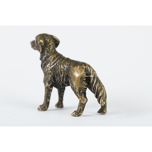 213 - A miniature bronze figure of a golden retriever dog.