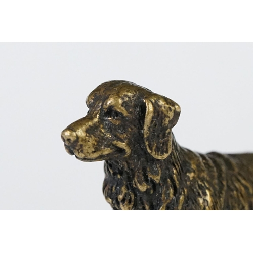 213 - A miniature bronze figure of a golden retriever dog.