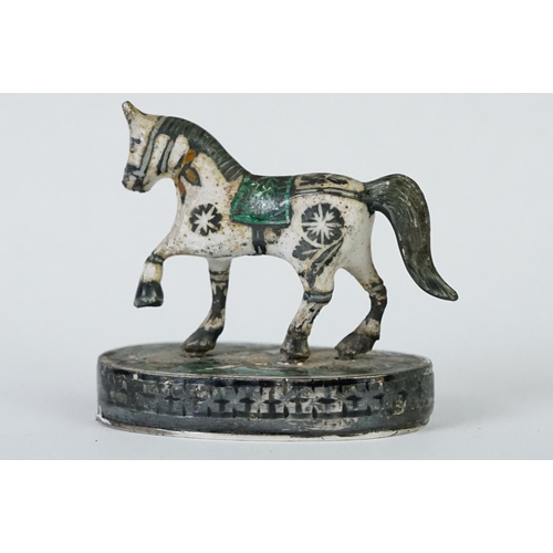 214 - A group of three Indian silver and enamel figures in the form of a camel, elephant and a horse.