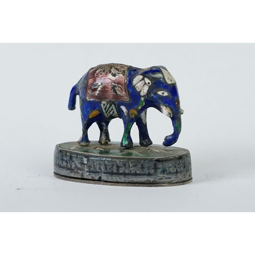 214 - A group of three Indian silver and enamel figures in the form of a camel, elephant and a horse.