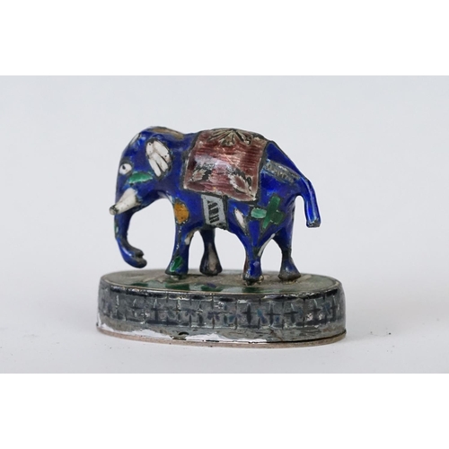 214 - A group of three Indian silver and enamel figures in the form of a camel, elephant and a horse.