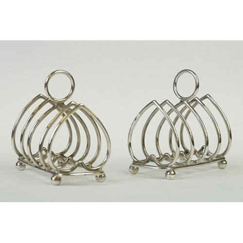 216 - Two fully hallmarked sterling silver four slice toast racks with heart decoration, assay marked for ... 