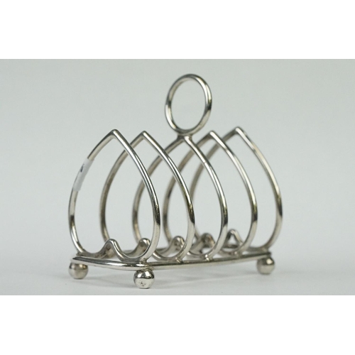 216 - Two fully hallmarked sterling silver four slice toast racks with heart decoration, assay marked for ... 