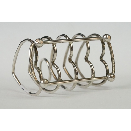 216 - Two fully hallmarked sterling silver four slice toast racks with heart decoration, assay marked for ... 