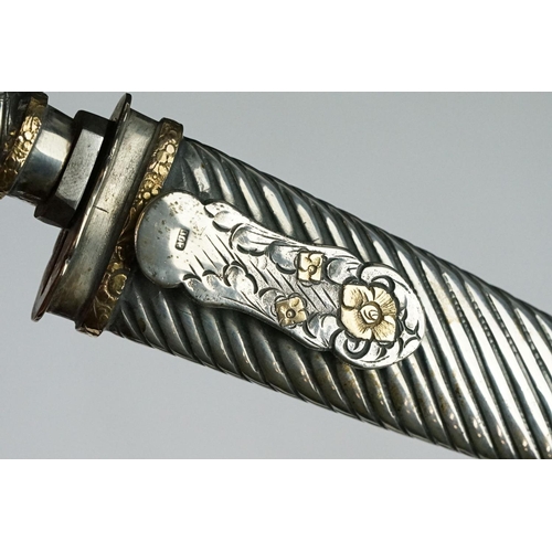 219 - An Argentinian silver handled Gaucho knife complete with matching silver scabbard.
