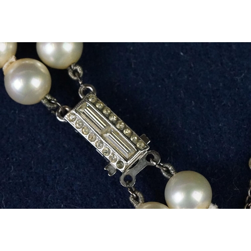 225 - A two row sautoir cultured pearl necklace with diamond set clasp.