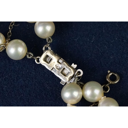 225 - A two row sautoir cultured pearl necklace with diamond set clasp.