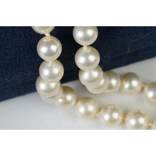 225 - A two row sautoir cultured pearl necklace with diamond set clasp.