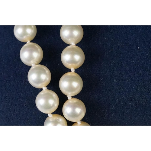 225 - A two row sautoir cultured pearl necklace with diamond set clasp.