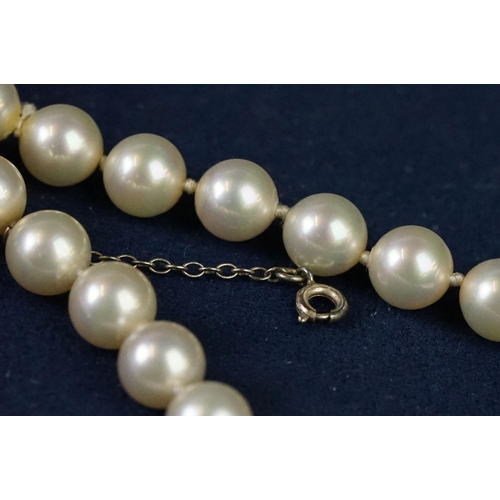 225 - A two row sautoir cultured pearl necklace with diamond set clasp.