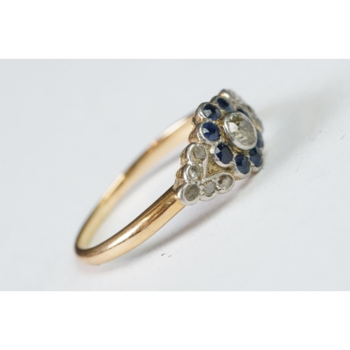 228 - A ladies yellow metal sapphire and diamond dress ring.