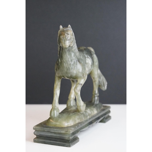 221 - An oriental carved jade figure in the form of a horse.