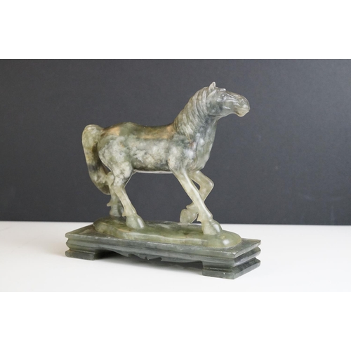 221 - An oriental carved jade figure in the form of a horse.