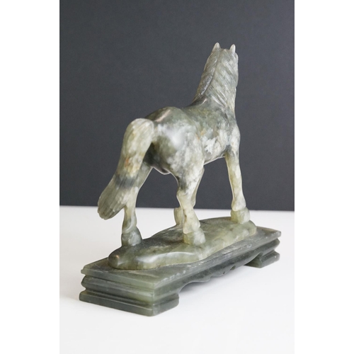 221 - An oriental carved jade figure in the form of a horse.