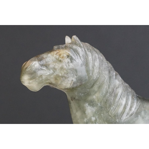 221 - An oriental carved jade figure in the form of a horse.