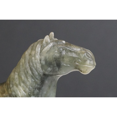 221 - An oriental carved jade figure in the form of a horse.