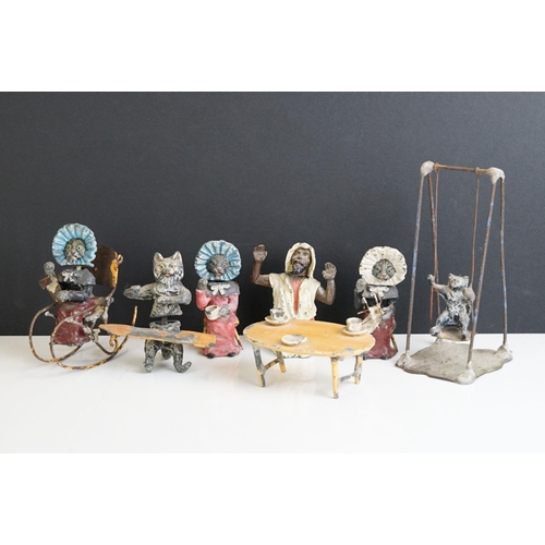 222 - A collection of five early 20th century cold painted spelter novelty cat figures together with a tab... 