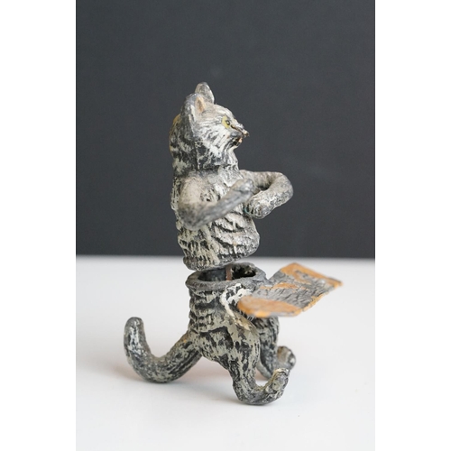 222 - A collection of five early 20th century cold painted spelter novelty cat figures together with a tab... 