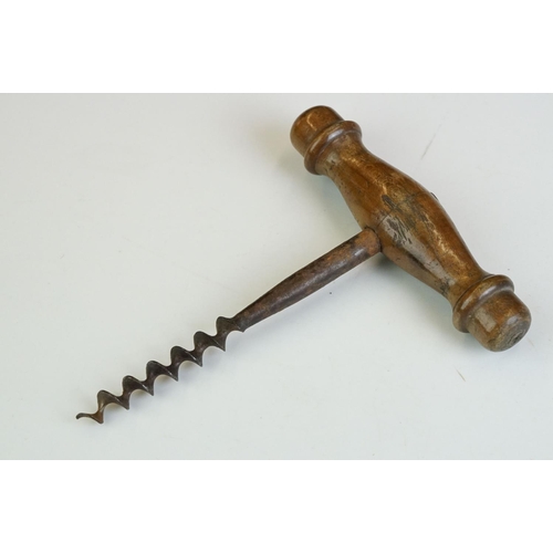 247 - Two antique wooden handled corkscrews together with a bottle opener in the form of a horse.