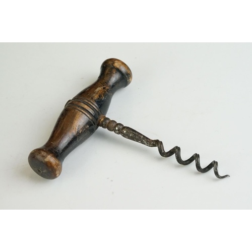 247 - Two antique wooden handled corkscrews together with a bottle opener in the form of a horse.