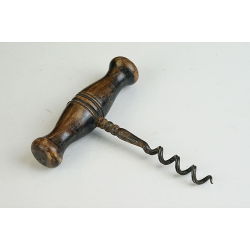 247 - Two antique wooden handled corkscrews together with a bottle opener in the form of a horse.