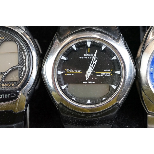 249 - A collection of nine wristwatches contained within a display case to include Casio examples.