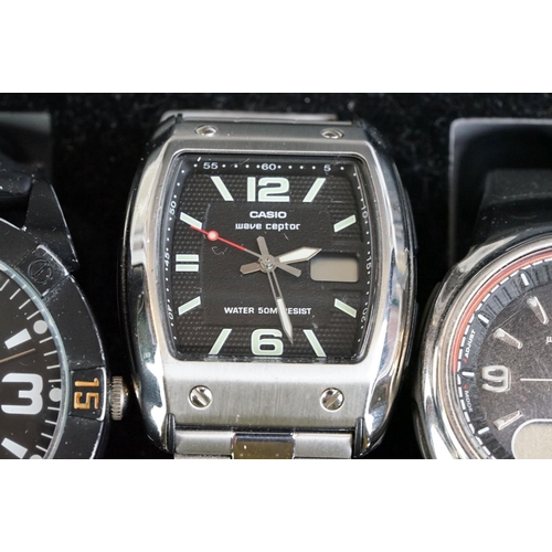 249 - A collection of nine wristwatches contained within a display case to include Casio examples.