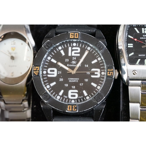 249 - A collection of nine wristwatches contained within a display case to include Casio examples.