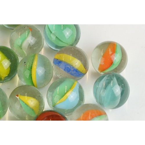 254 - A small collection of vintage glass marbles contained within two bags.