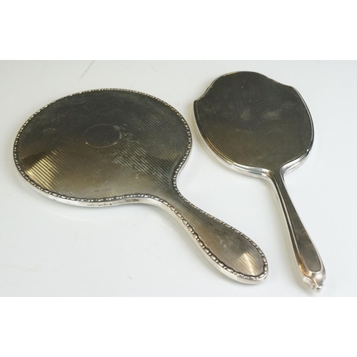 257 - Two fully hallmarked sterling silver hand mirrors, both with engine turned decoration.