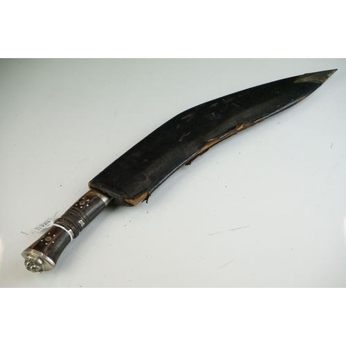 269 - Two vintage Indian Kukri knives, the smaller with brass trim and the large with white metal, both co... 