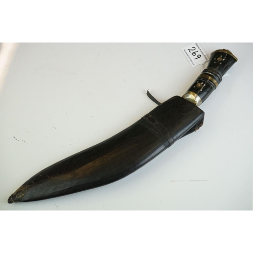 269 - Two vintage Indian Kukri knives, the smaller with brass trim and the large with white metal, both co... 