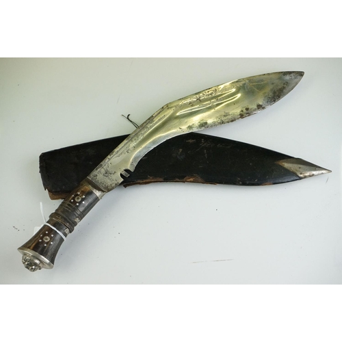 269 - Two vintage Indian Kukri knives, the smaller with brass trim and the large with white metal, both co... 