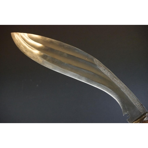 271 - A vintage full size kukri knife with bone inlay decoration to the handle, complete with scabbard.