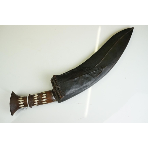 271 - A vintage full size kukri knife with bone inlay decoration to the handle, complete with scabbard.