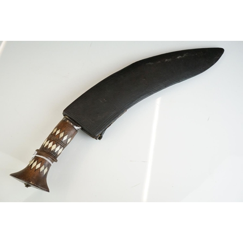 271 - A vintage full size kukri knife with bone inlay decoration to the handle, complete with scabbard.