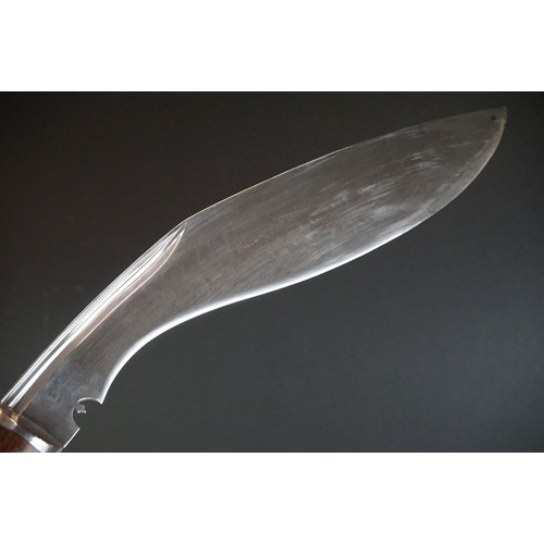 272 - A vintage full size kukri knife with wooden handle and fullered steel blade, complete with original ... 