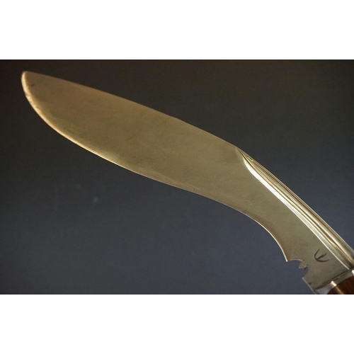 272 - A vintage full size kukri knife with wooden handle and fullered steel blade, complete with original ... 