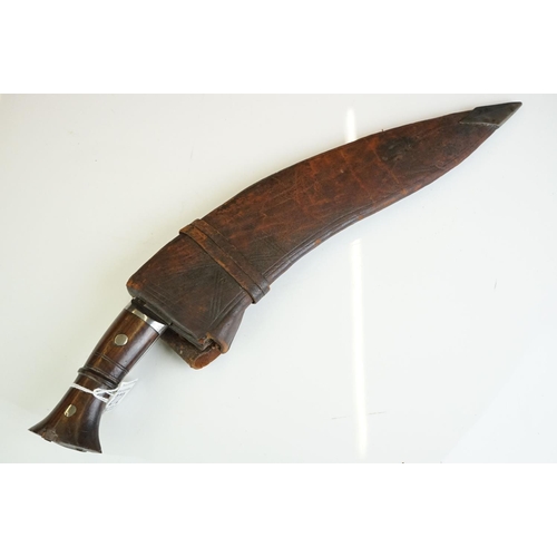 272 - A vintage full size kukri knife with wooden handle and fullered steel blade, complete with original ... 