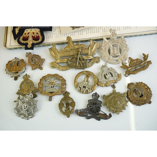 273 - A group of military collectables to include Head Dress Badges of the British Army books in two volum... 